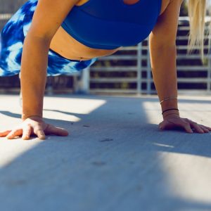 woman planking on gray asphalt road